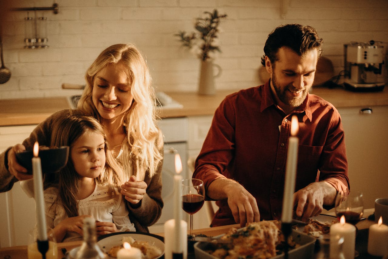 Family enjoying a cozy holiday dinner together, sharing love and joy indoors.